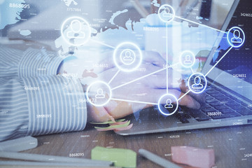 Social network theme hologram with businessman working on computer on background. Concept of world wide web. Multi exposure.