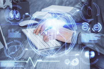 Science hologram with man working on computer on background. Concept of study. Double exposure.