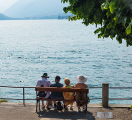 Four Senior People Look Out Over Lake