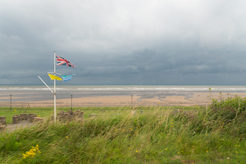 British Union Jack Flag flies on Shoreline