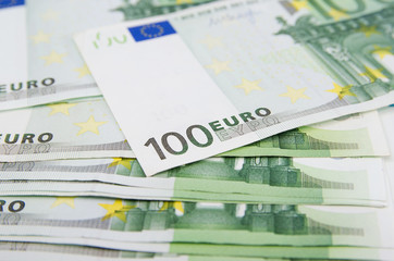 many banknotes of 100 Euro, the European currency, the concept of income and inflation