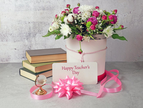 Stack Of Books And A Bouquet Of Flowers On Artistic Background. Teacher's Day Card.