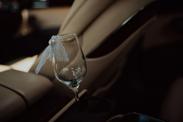 bottle of champagne and glass in luxury car