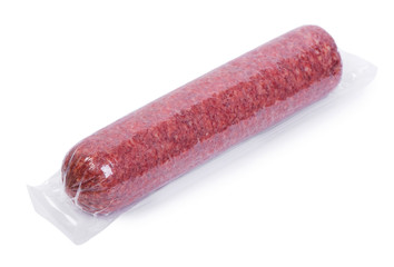 Vacuum packed salami sausage isolated on white