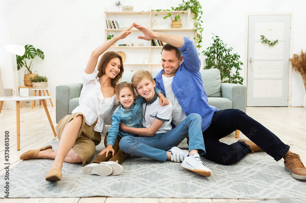 Wall mural Parents Making Symbolic Roof Joining Hands Above Kids Sitting Indoors