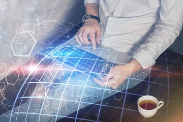 Fototapeta na wymiar Double exposure of world map hologram with man working on computer on background. Concept of worldwideweb.