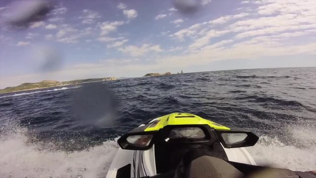 Driving a jet ski on a rough wave water Sea on a Mediterranean Sea in Costa Brava, Catalonia from a driver point of view