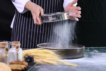 Chef is Sifting the Flour to make Bread
