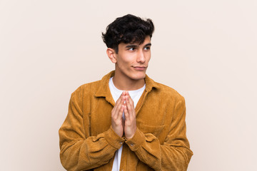 Young Argentinian man over isolated background scheming something