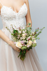 Obraz na płótnie Canvas beautiful bride holding bridal bouquet