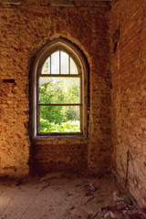 An openwork window in an old brick estate