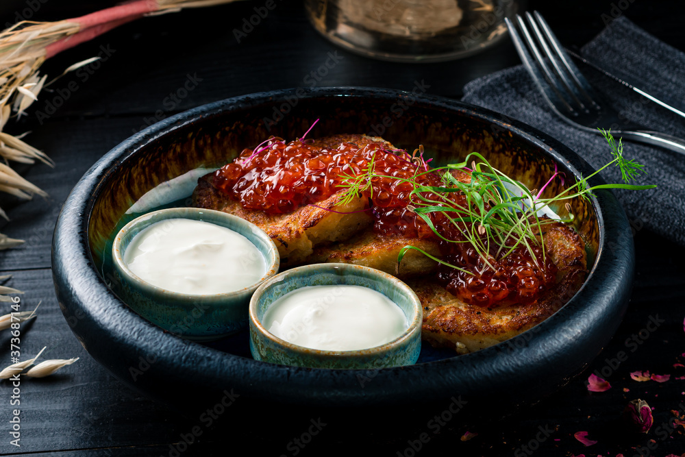 Sticker potato pancakes with red caviar