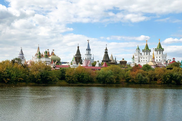 architectural ensemble in the Russian style among the yellowed autumn trees is reflected in the...