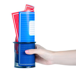 Hand holding school exercise book in stand on white background isolation