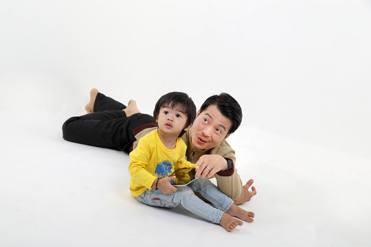 South East Asian Father Son Child Playing Talking With Tablet Pc Tab On White Background Show Point