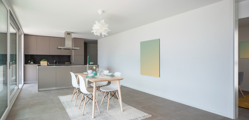 Designer set table. Behind the modern designer kitchen with island