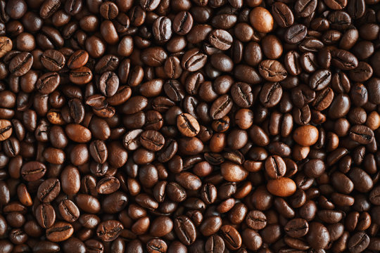 The background is made of high-quality natural aromatic roasted coffee beans, which will be ground and become a delicious coffee drink. © Valeri Vatel