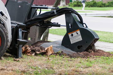 machine chops a stump on the street, close-up