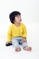 South East Asian young boy child playing looking up on white background