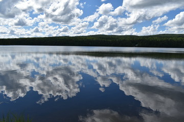 The reflection of the clouds on the square lake, Sainte-Apolline, Quebec
