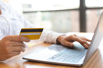 Girl using laptop and credit card at home