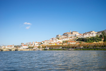 Fototapeta na wymiar Coimbra cityscape seen from Mondego river, Portugal