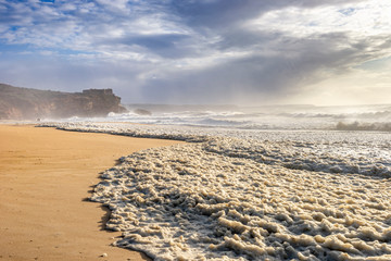 Restless sea at North Beach of famous Nazare, Portugal