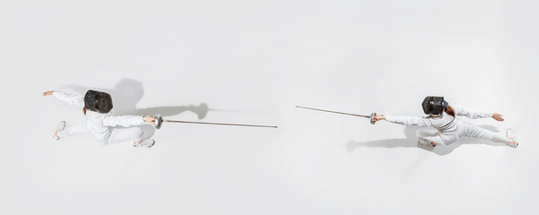 First. Teen girl in fencing costume with sword in hand on white background. Top view. Young female model practicing and training in motion, action. Copyspace. Sport, youth, healthy lifestyle. Collage.