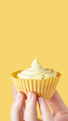 Yellow monochrome bakery. Sustainable cupcake cup. Hold in hand. Gold maffin cream. Trendy colourful desert. Bright birthday gift. Vertical banner for story. Copyspace