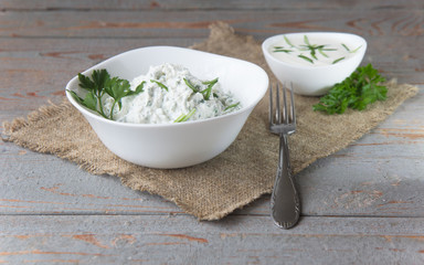 Homemade cottage cheese with herbs on a rustic.