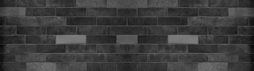 Black anthracite dark gray grey brick tiles wall texture wide background banner panorama	