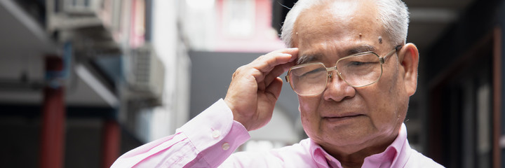 Banner of sick asian senior man suffering from headache; health and sickness concept for vertigo,...