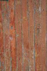 Old red colored wooden tiles, vintage boards. Rough aged wood panels, texture background. 