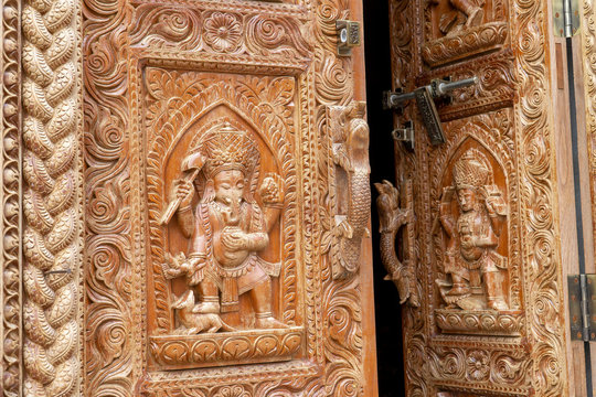 Nepal Kathmandu temple of Changu Narayan, view of an ancient wooden door carved with sacred images.