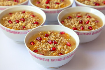 Turkish dessert Ashura, Noah's pudding, with pomegranate seeds and walnut