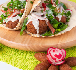Falafel, traditional Lebanese food, topped with special dip. 