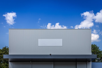 Modern factory facade with blue sky