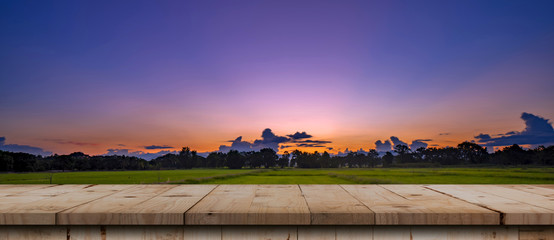 Rice field sunset and Empty wood table for product display and montage.
