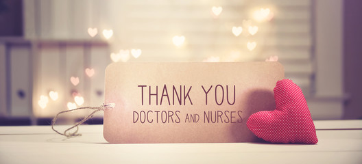 Thank You Doctors and Nurses message with a red heart with heart shaped lights