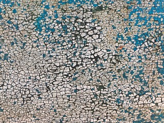 Fototapeta premium Background of white, peeling paint on an old wall