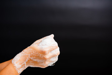 Closeup body care Asian young woman washing hands with soap have foam, hygiene prevention COVID-19 or coronavirus protection concept, isolated on black background