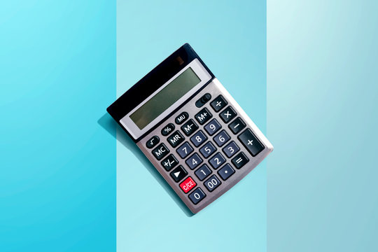 Calculator with shadow overhead view - flat lay