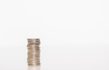 silver coin stack row growing pile on white background for money saving and investment business financial and banking concept.