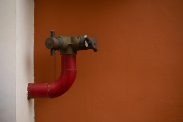 Old fire hydrant fit to the building wall , Fire protective system , Fire equipment