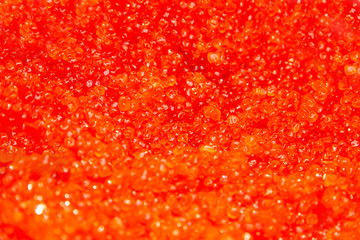 Background of salmon and trout red caviar. Seafood. Expensive delicatessen from sea. Macro shot , focus on a center