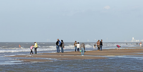 Autumn at the beach near Noordwijk;  on the horizon smoke stacks in IJmuiden and buildings of Zandvoort