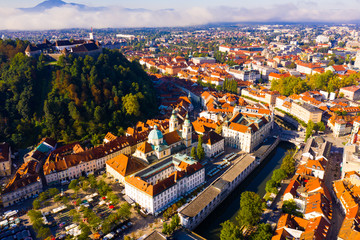 Aerial view of Slovenian town of Ljubljana overlooking fortified castle on hill and Roman Catholic...