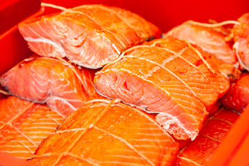 Sale of smoked Kamchatka fish. Far Eastern seafood, natural smoked fish - sockeye salmon at the city Christmas market