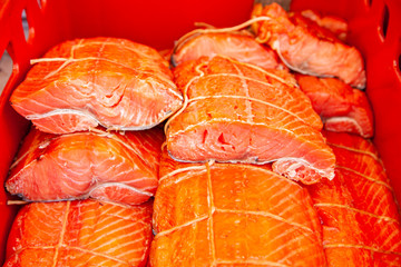 Sale of smoked Kamchatka fish. Far Eastern seafood, natural smoked fish - sockeye salmon at the city Christmas market