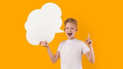 Smiling teenage boy pointing up at speech bubble